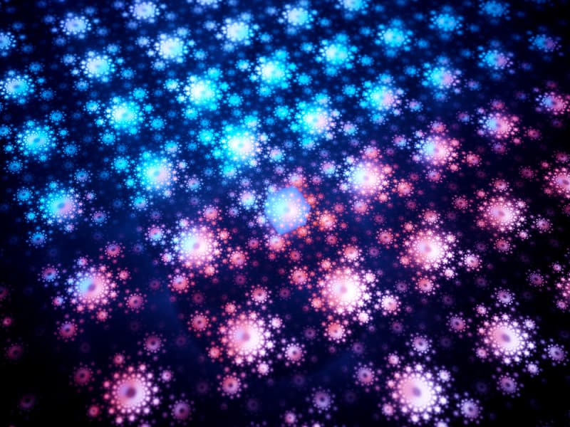 Close up of a Quantum computer chip graphic, lit in blue and pink Quantum computer