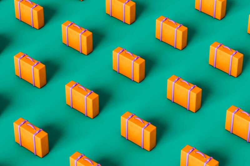 Orange suitcases on green background