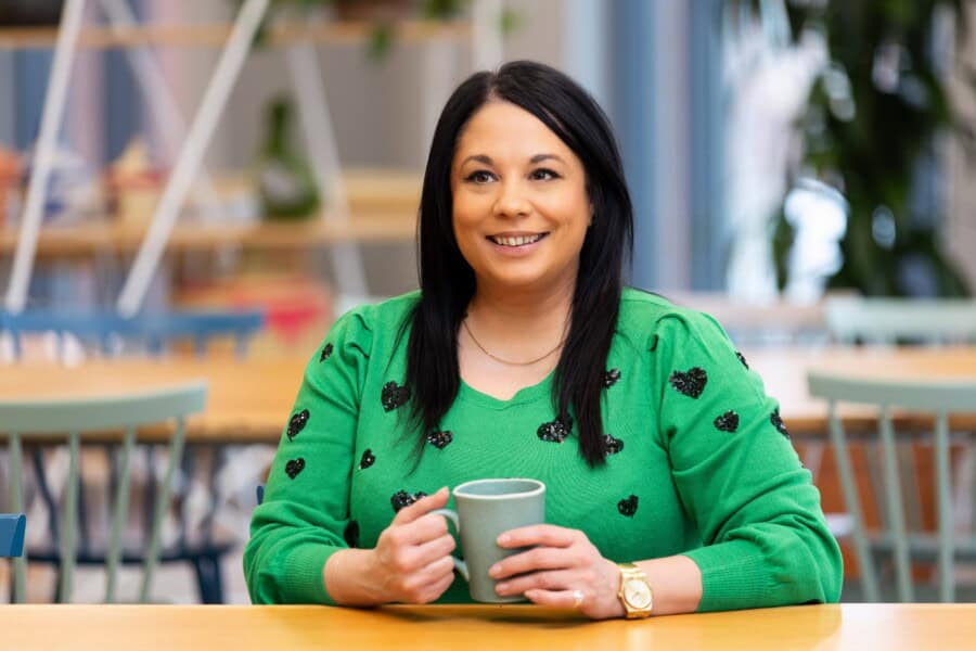 ForrestBrown Patent Box expert Angela Banerjee at a table with a coffee