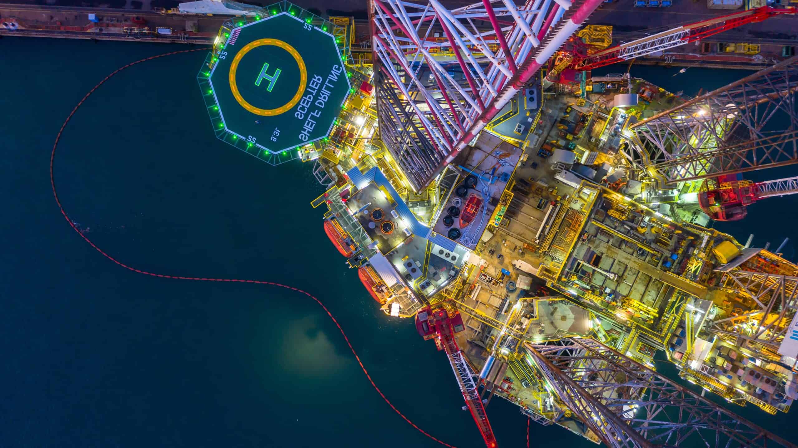 Aerial view offshore jack up rig at night, Offshore oil rig drilling platform.