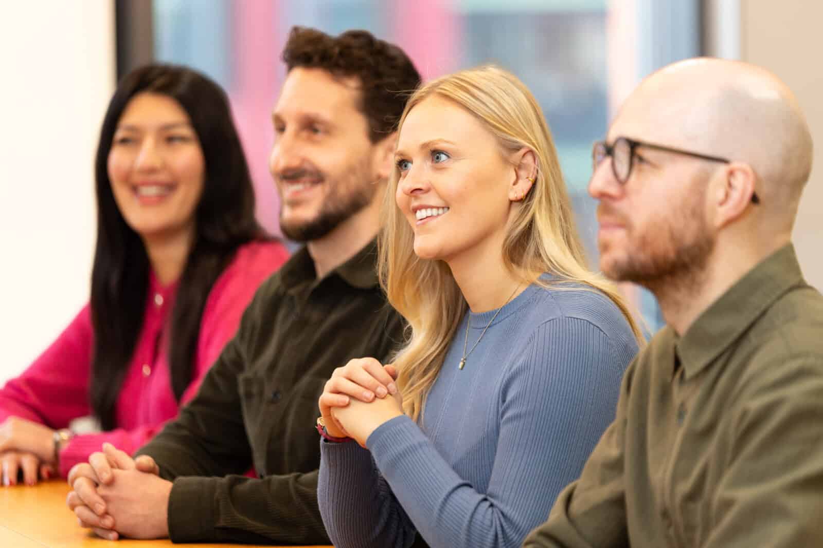 A group of ForrestBrown people listening intently