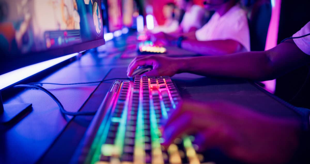 Game developers working in a team. Close-up hand on a computer keyboard.