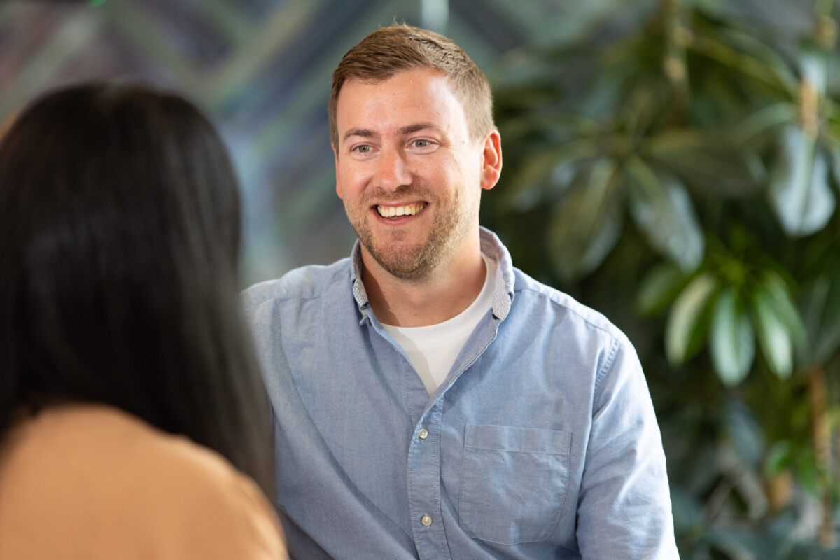 Tom Jones, Director at ForrestBrown, speaking with a colleague